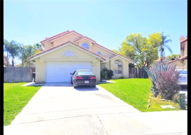 view of front facade with a garage and a front yard