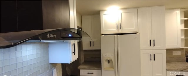 kitchen featuring ventilation hood, white refrigerator with ice dispenser, and white cabinets