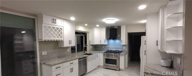 kitchen featuring appliances with stainless steel finishes, wall chimney range hood, and white cabinets