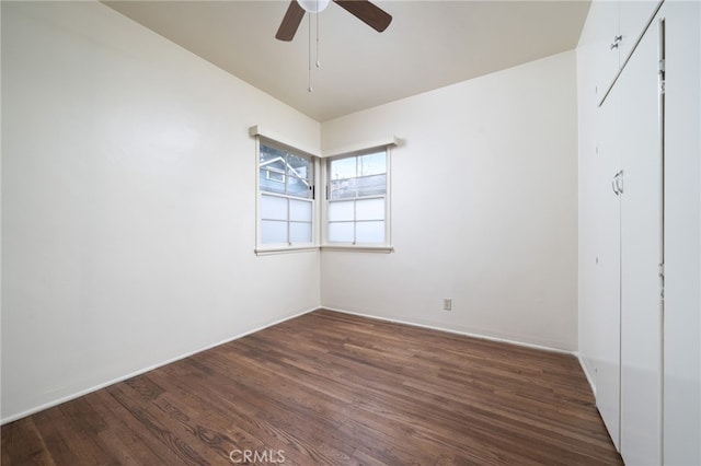 unfurnished room featuring ceiling fan and dark hardwood / wood-style flooring