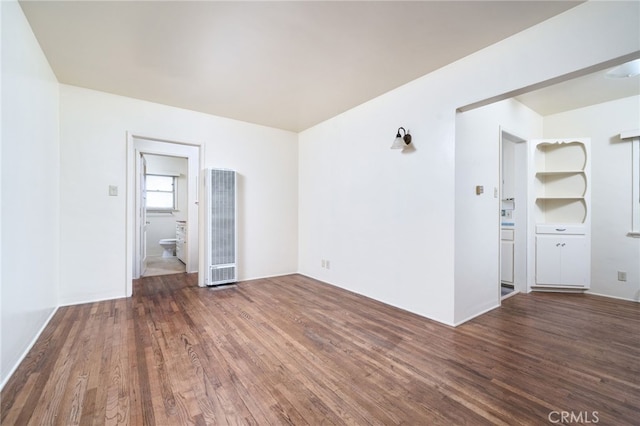 empty room with dark hardwood / wood-style floors