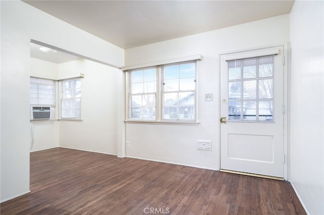 interior space featuring plenty of natural light, cooling unit, and dark hardwood / wood-style floors