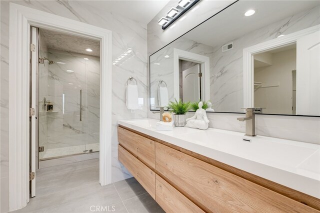 bathroom featuring vanity and an enclosed shower