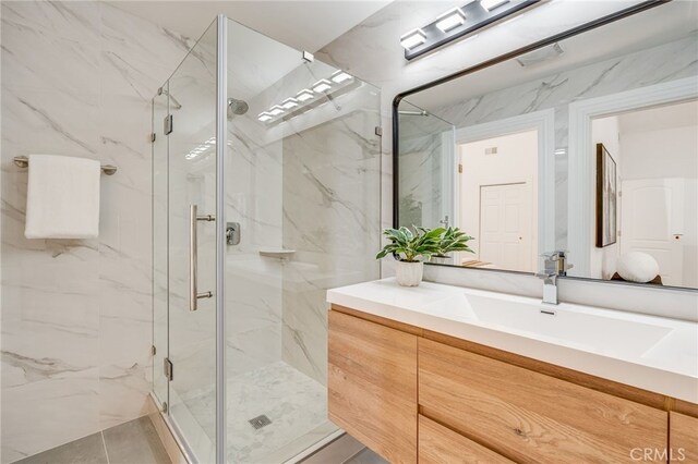 bathroom featuring an enclosed shower and vanity