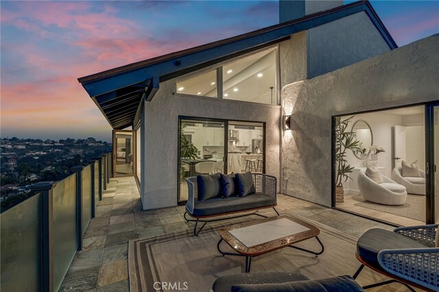 patio terrace at dusk with a balcony