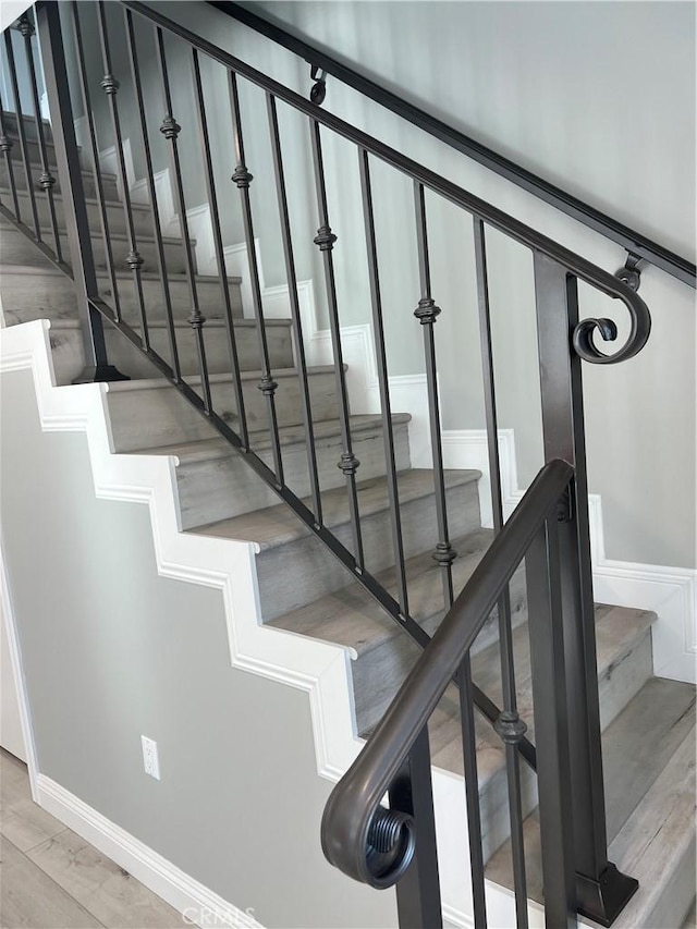 stairs featuring hardwood / wood-style flooring