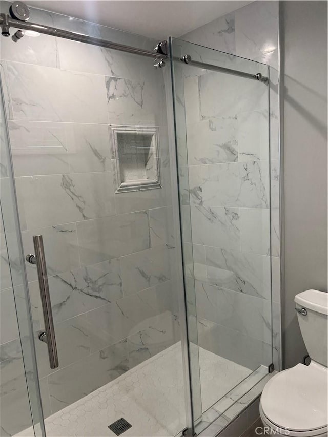 bathroom with toilet and walk in shower