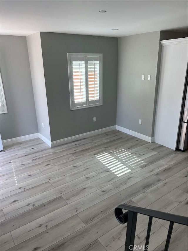 unfurnished room featuring light hardwood / wood-style floors