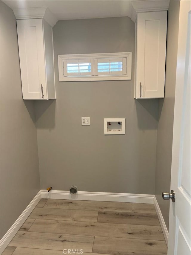 clothes washing area with washer hookup, light wood-type flooring, and hookup for a gas dryer