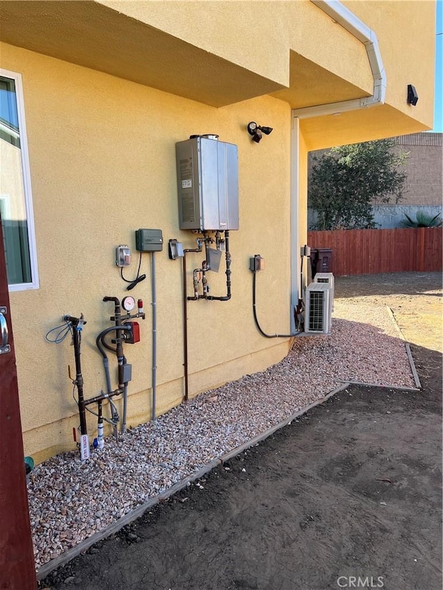 view of home's exterior featuring ac unit and water heater