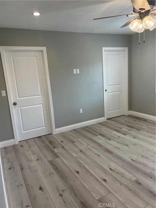 spare room featuring ceiling fan and light hardwood / wood-style flooring