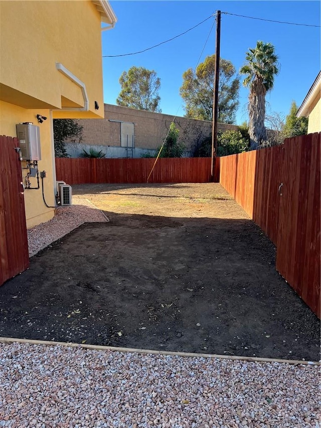 view of yard with tankless water heater