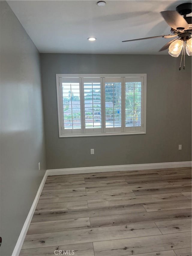 unfurnished room with ceiling fan and light hardwood / wood-style flooring