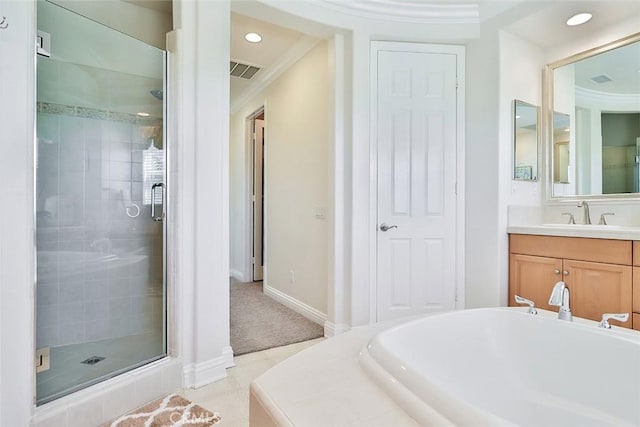 bathroom with vanity, ornamental molding, and independent shower and bath