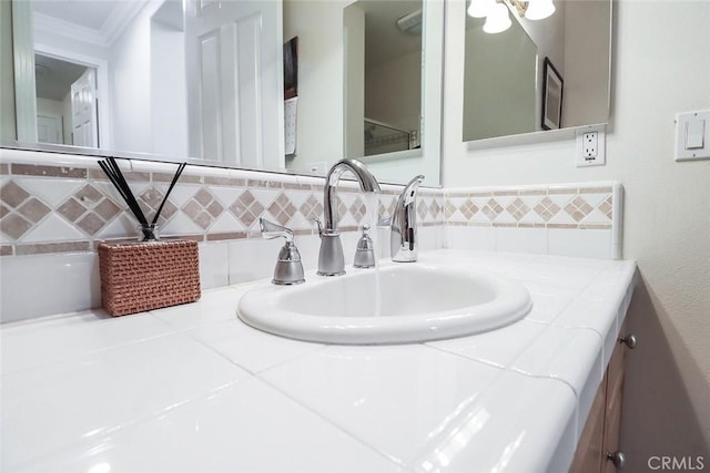 bathroom featuring crown molding and vanity