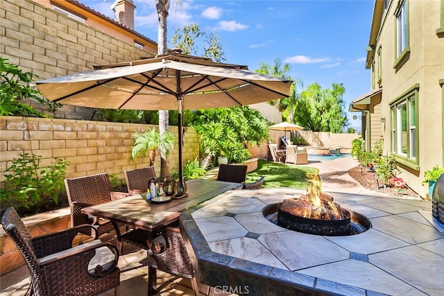 view of patio / terrace featuring an outdoor fire pit