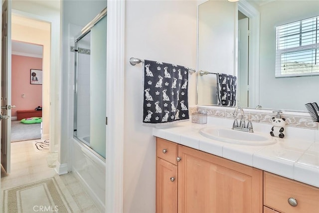 bathroom with combined bath / shower with glass door and vanity