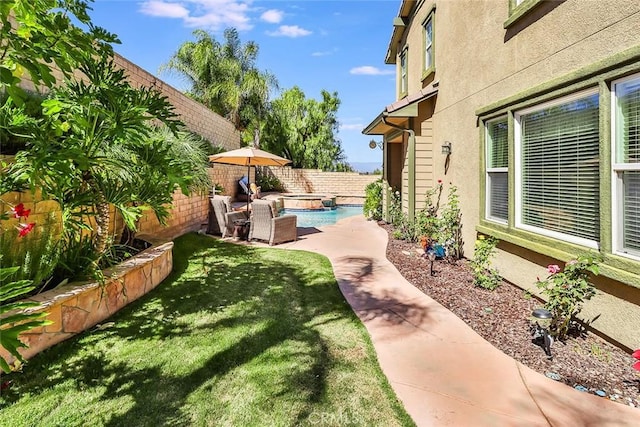 view of yard with a fenced in pool and a patio area