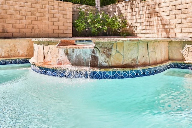 view of pool with pool water feature