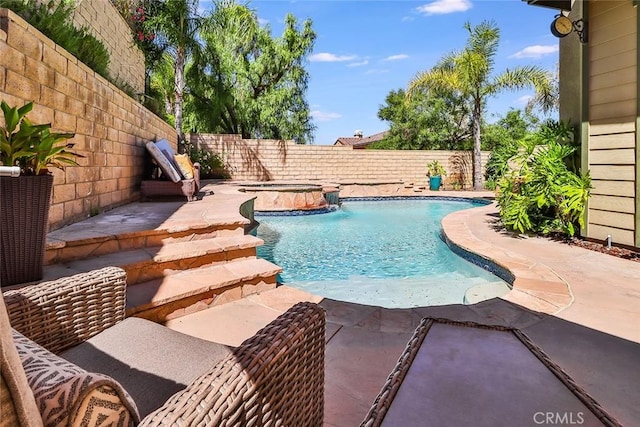 view of swimming pool featuring pool water feature, an in ground hot tub, and a patio