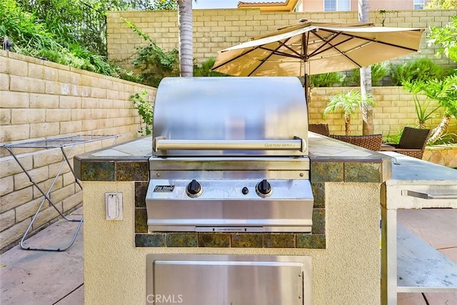 view of patio featuring area for grilling and exterior kitchen