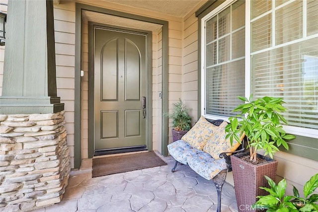 view of exterior entry with covered porch