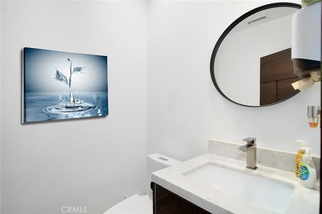 bathroom featuring toilet and vanity