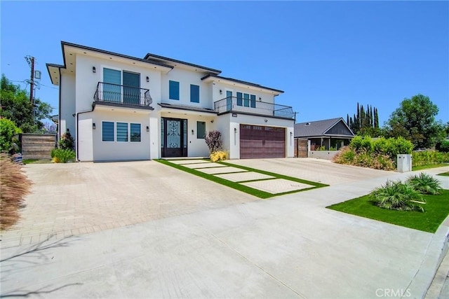 view of front of house with a garage and a balcony