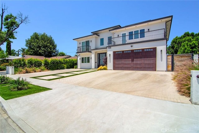 view of front of home featuring a balcony and a garage