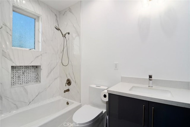 full bathroom with toilet, vanity, and tiled shower / bath combo