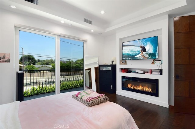 bedroom featuring dark wood-type flooring and access to exterior