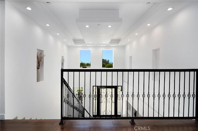 hallway featuring a tray ceiling