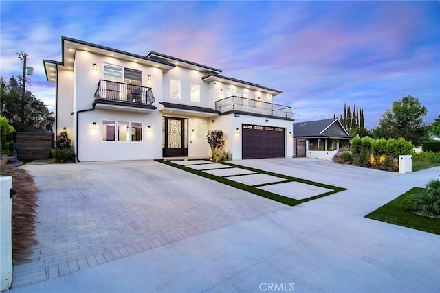 contemporary home with a balcony and a garage