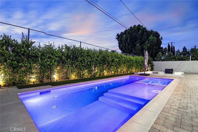 view of pool at dusk