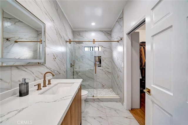 bathroom featuring a shower with shower door, toilet, and vanity