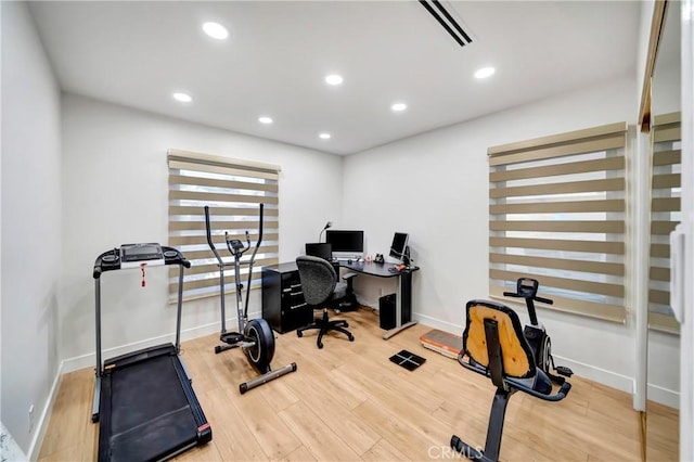 workout area with hardwood / wood-style flooring