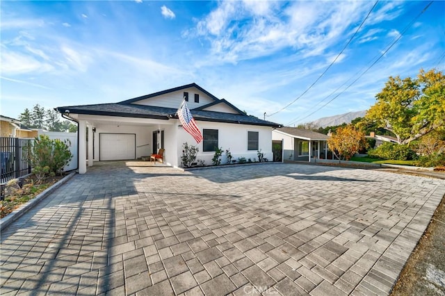 view of front of home with a mountain view and a garage