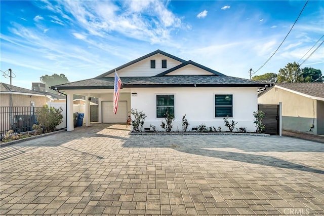 view of front of house with a carport and a garage