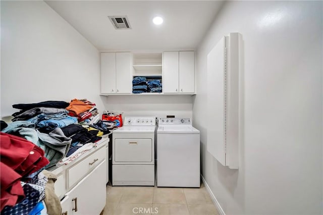 washroom with cabinets, light tile patterned floors, and independent washer and dryer