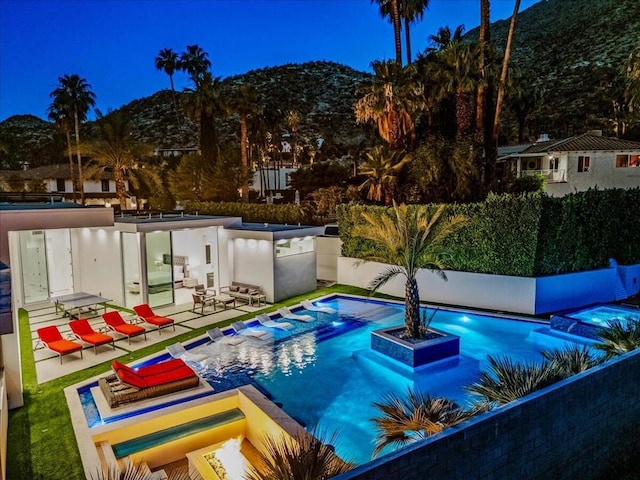 view of swimming pool with a patio area and a mountain view