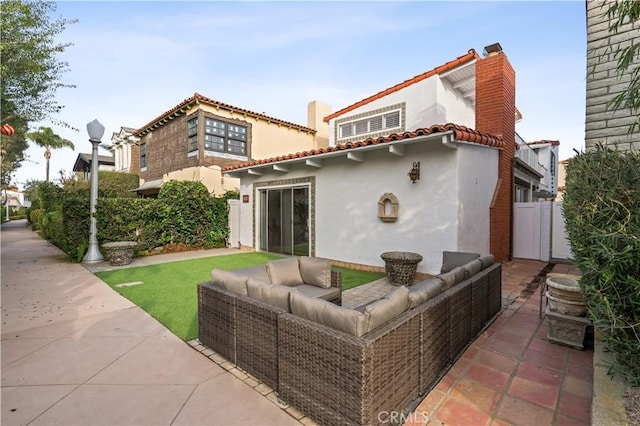 rear view of house with an outdoor hangout area and a patio area