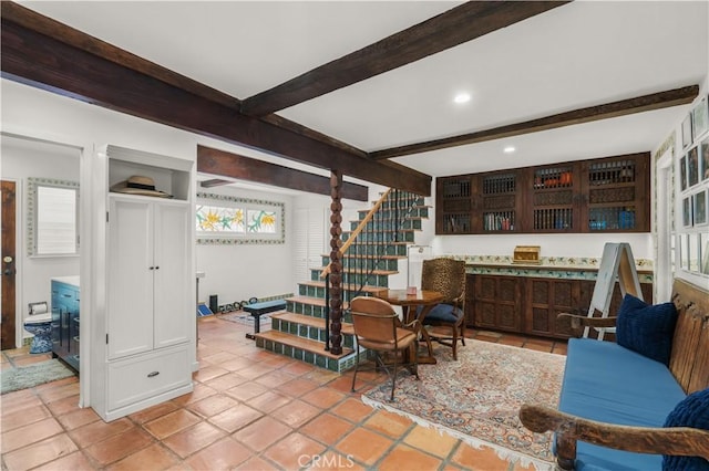 interior space with light tile patterned floors and beamed ceiling