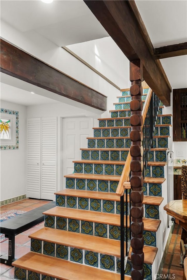 stairway featuring tile patterned flooring