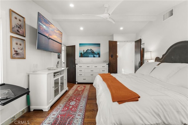 bedroom featuring ceiling fan, dark hardwood / wood-style floors, and beamed ceiling