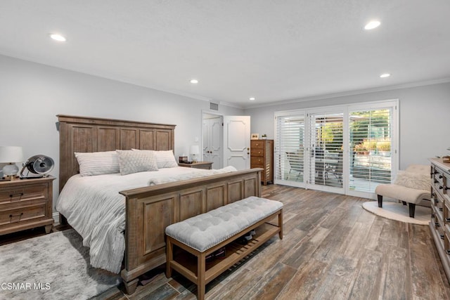 bedroom with crown molding, dark hardwood / wood-style floors, and access to outside