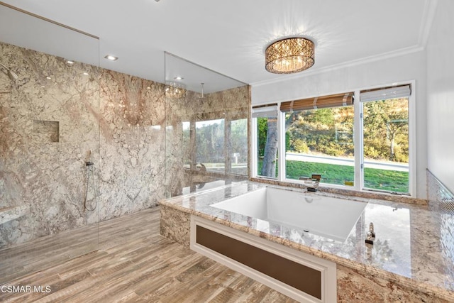 bathroom featuring hardwood / wood-style floors, crown molding, and shower with separate bathtub