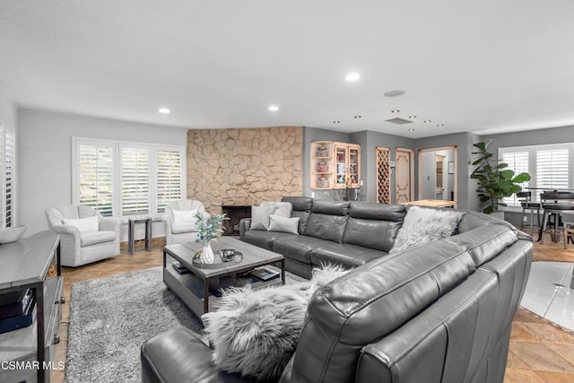 living room with plenty of natural light, light tile patterned floors, and a fireplace