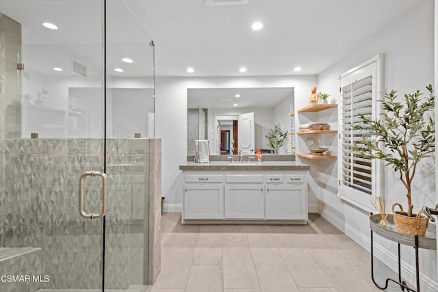 bathroom featuring vanity, tile patterned flooring, and a shower with door