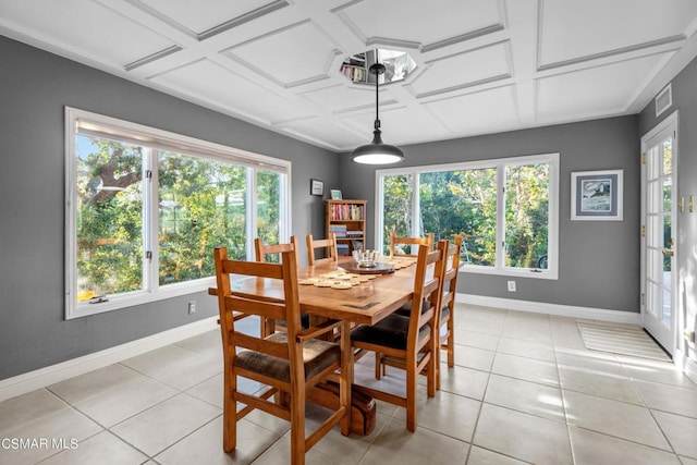 tiled dining space featuring coffered ceiling