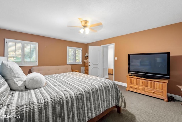 carpeted bedroom featuring ceiling fan and multiple windows